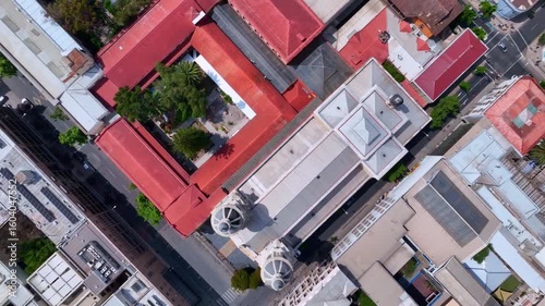 Top-Down Drone Shot of Historic Church in Downtown Santiago Surrounded by Colorful Rooftops and City Streets
