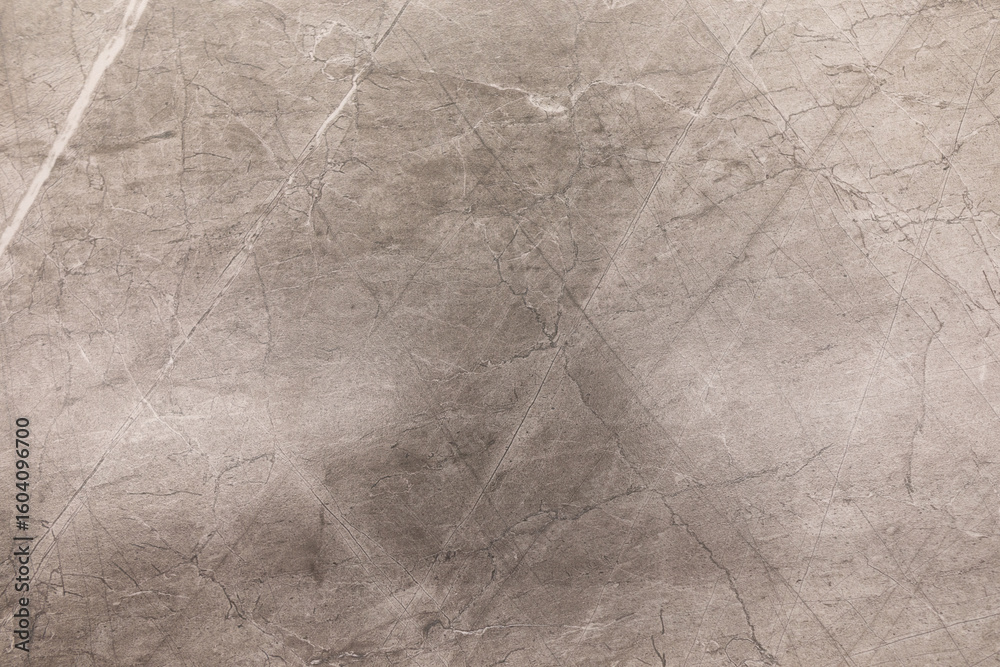 Obraz premium Concrete texture with scratches and markings displayed in neutral tones and soft lighting
