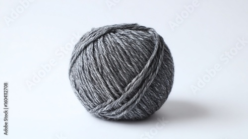 A gray ball of yarn on a white background