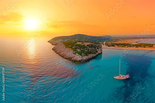 Fototapeta Naklejka Na Ścianę i Meble -  Sunset with boat over Voidokilia Bay, Greece – one of the most beautiful beaches in the Mediterranean sea