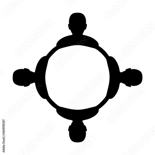 Four people sitting around a round table in a collaborative teamwork setting