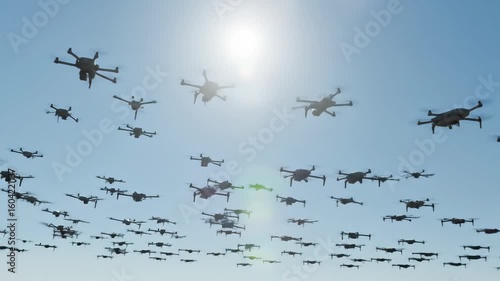 Numerous modern quadcopter drones flying in formation against a bright clear blue sky