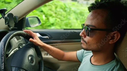 Man in goggles steers the car with full focus
