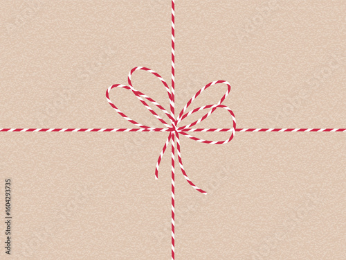 Craft Christmas paper background with red white candy stripe bow. Textured gift wrap. Template for holiday card, present tag, packaging design, Xmas, New Year greeting template