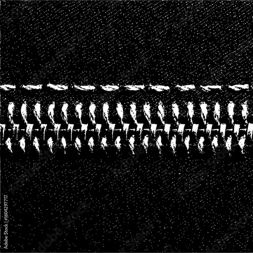 Close up of a black fabric material with a white zipper and white stitching in a horizontal line