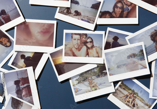 Mockup of Several polaroids are scattered randomly on a dark navy blue surface