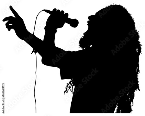 Silhouette of a male reggae singer singing in to a microphone 