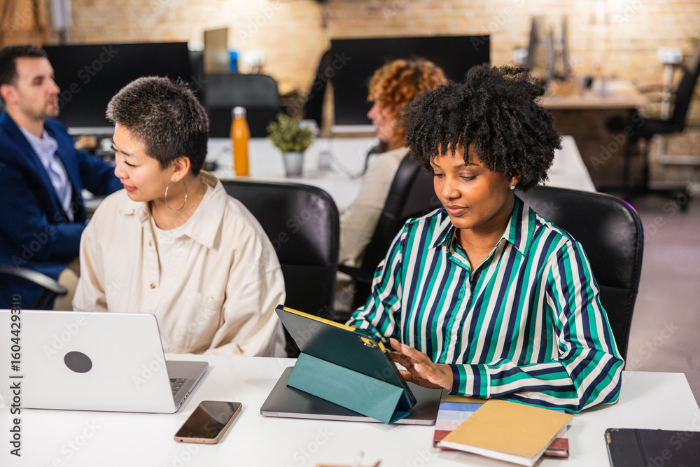 Multi ethnic team working together in modern office using digital tablet and laptop Multi ethnic team working together in modern office using digital tablet and laptop