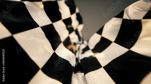 Waving Checkered Flag Symbolizing Victory in Motorsport Racing with Dynamic Motion and Bold Black and White Pattern Against a Neutral Backdrop