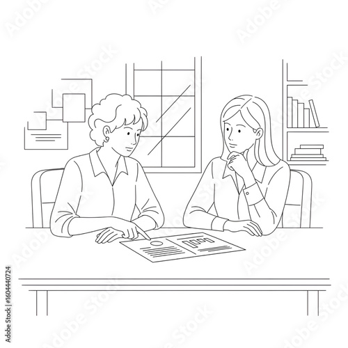Two women sitting at a table discussing