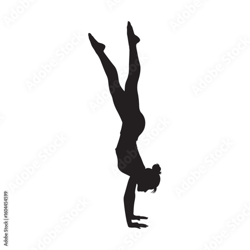 Silhouette of a gymnast performing a graceful handstand with legs extended upwards in a dynamic pose