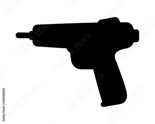 Black silhouette of a power drill standing on a white surface backdrop