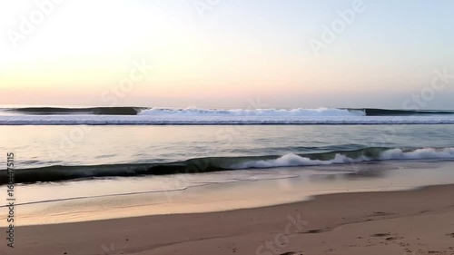 Wallpaper Mural Sunset glow over the sea with waves gently washing the sandy beach,  A serene view of a peaceful beach at dawn, with soft waves lapping at the shore, High-quality landscapes nature video footage  Torontodigital.ca