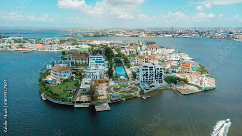 Aerial view of opulent residences nestled on an island surrounded by the vast, shimmering waters of Lagos Lagoon, a testament to luxury living, Lagos, Lagos, Nigeria.