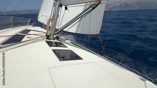 Bow of a sailing yacht cutting through the sea with sails fully open near Croatia. Freedom, motion, clean energy and slow travel on the open water.