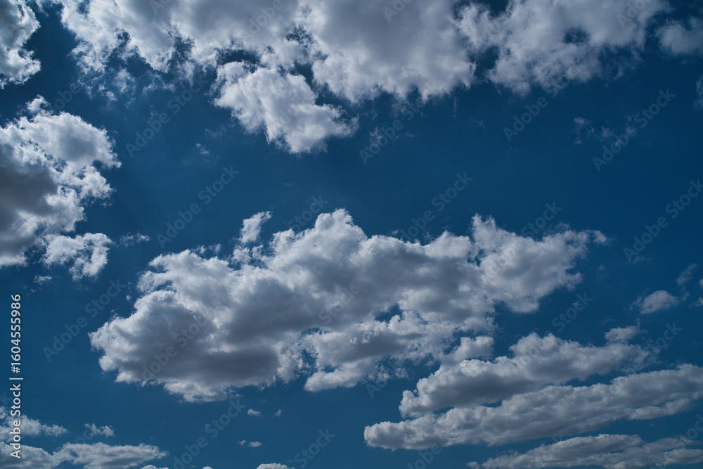 Obraz premium storm clouds float across the blue sky
