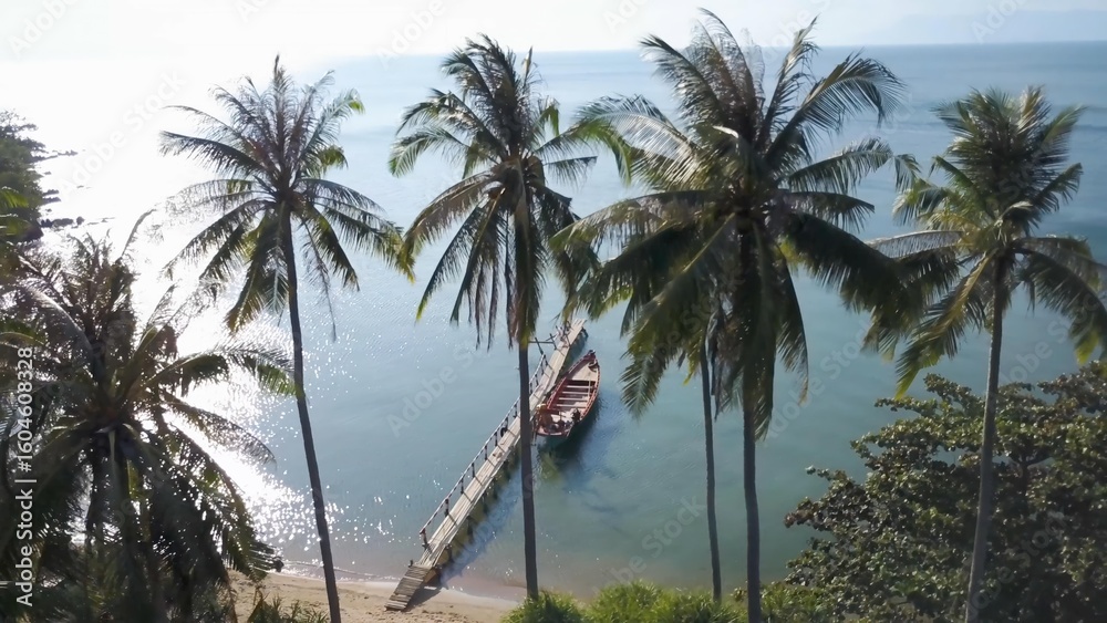 Obraz premium Witness the stunning aerial beauty of Koh Tonsay, Cambodia, as the sun rises over the tranquil waters, surrounded by palm trees and picturesque beaches.