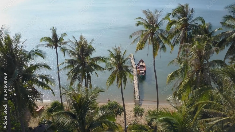 Obraz premium Explore the stunning aerial views of Koh Tonsay Island in Cambodia at sunrise, showcasing serene waters, palm trees, and a tranquil atmosphere perfect for relaxation.