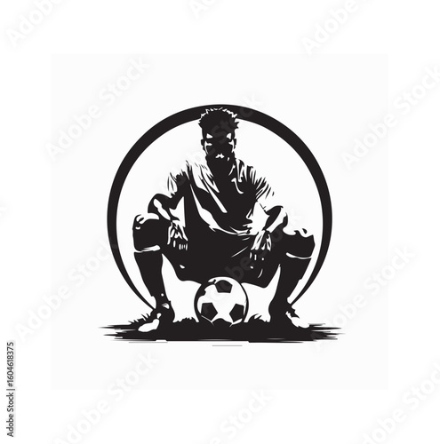 Silhouette of Man Sitting with Soccer Ball in Front on the Ground