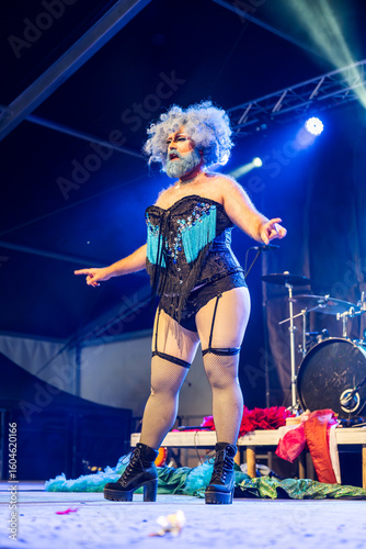 Obraz na plátne Drag queen performing on stage during night show, wearing extravagant costume an