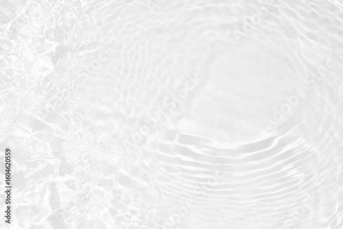 White water with ripples on the surface. Defocus blurred transparent white colored clear calm water surface texture with splashes and bubbles. Water waves with shining pattern texture background.