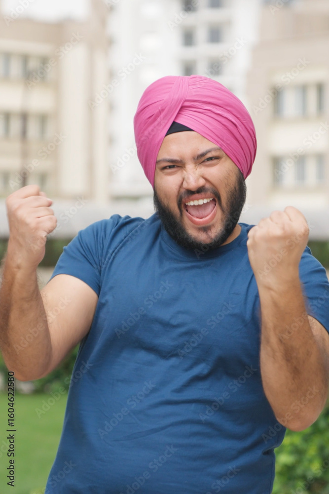Naklejka premium Vertical Photo of Sikh Indian Man Celebrating
