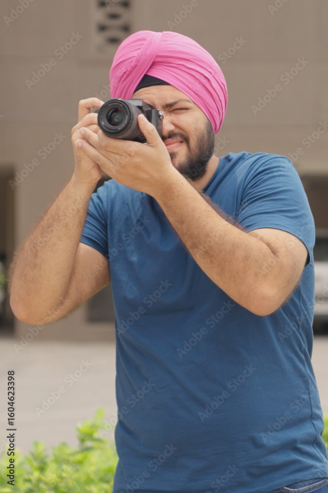 Fototapeta premium Vertical Photo of Sikh Indian Man Clicking Picture with Camera