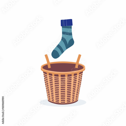 Laundry basket with sock jumping out – Woven basket mid-topple as a sock springs free.

