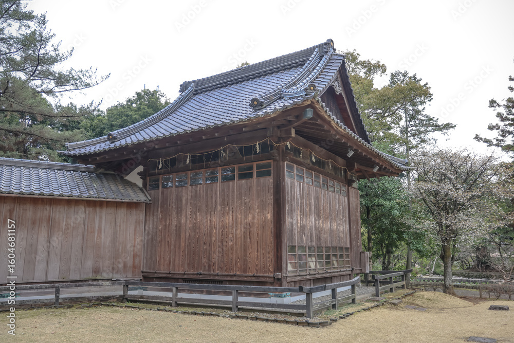 Fototapeta premium March 24 2025 Traditional Japanese Wooden Building Amid Lush Greenery, Japan