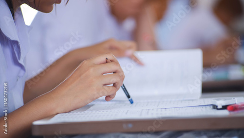 The students were doing the exams inside the classroom with stress.Assessment examination of high school students