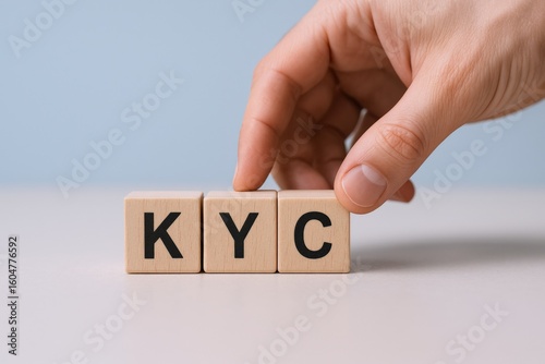 Hand Placing Wooden Blocks with Letters KY C on a White Surface for Creative Text Arrangement, Minimalist Modern Design