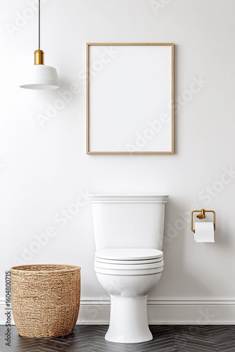 Modern bathroom design featuring a white toilet, decorative basket, and stylish lighting along with a blank wall. Empty vertical frame for modern wall art mockup
