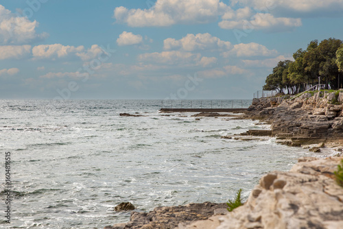 Fototapeta Naklejka Na Ścianę i Meble -  Mediterranean coastal landscape with rocky cliffs and pier. Istria, Croatia.