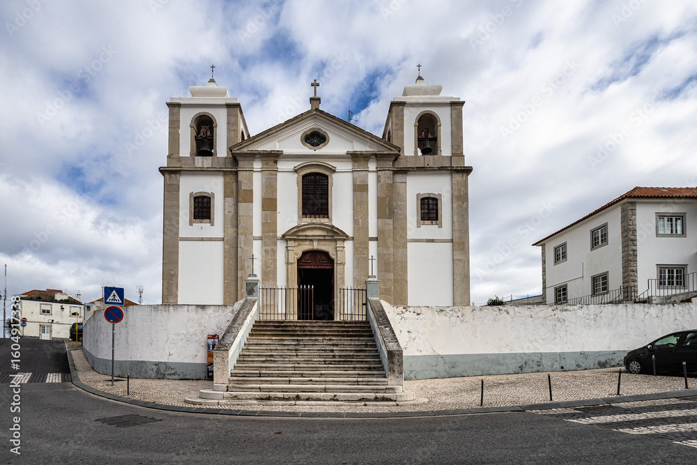 Obraz premium Old Sao Pedro Church facade and staircase in Palmela, Portugal under a blue cloudy sky near Setubal