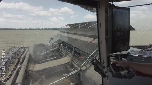 Modern Combine Harvester Operating in Golden Wheat Field during Harvest Season