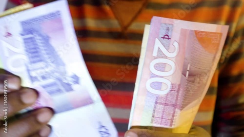  Black African person counting of Various Ghanaian cedi notes denominations