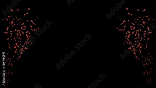 Confetti in red and yellow rising on both sides of a black background for a festive celebration effect

