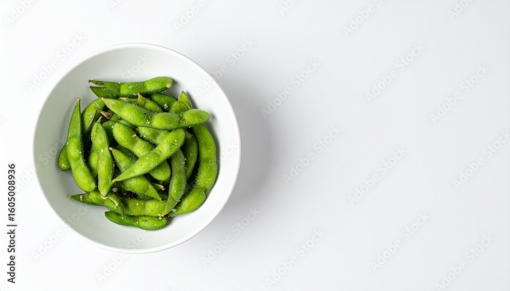 Delicious salted edamame pods in a white bowl ready to enjoy as a healthy snack Delicious salted edamame pods in a white bowl ready to enjoy as a healthy snack