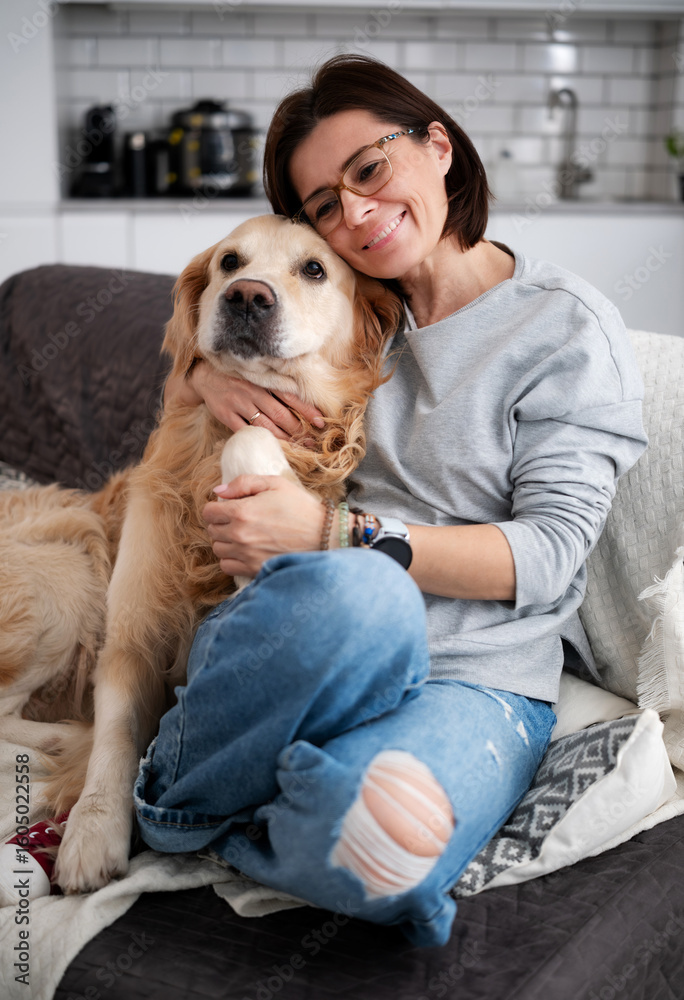 Obraz premium Happy Woman Hugging Adorable Dog And Relaxing At Home