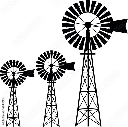 Three black silhouette windmills of varying sizes on white background farm