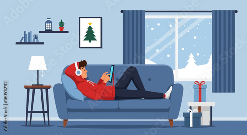 Cozy Winter: Young Man Relaxing at Home with Tablet During Christmas Time