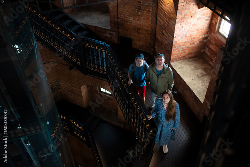 Photos family in olaf's tower in vyborg castle on a spiral staircase in the dark