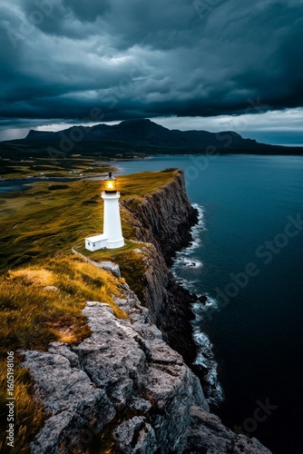Light From the Lighthouse Guides Ships Along the Rugged Coast Under Dark Skies