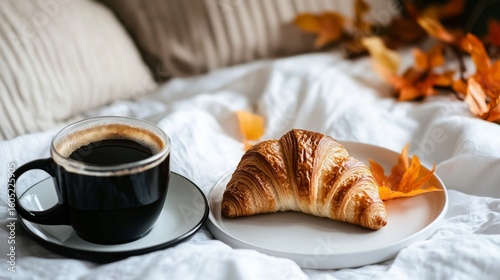 Enjoying Coffee and Croissant With Autumn Leaves on a Cozy Bed During a Peace...
