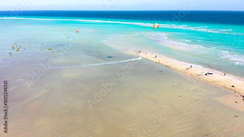 Aerial view of a crowd of kitesurfers enjoying the waves on the beach of Sotavento, Fuerteventura Island, Spain.