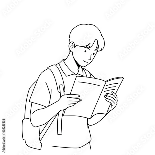 Young man reading book while standing and smiling with backpack  