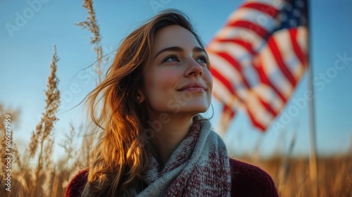 Young Woman Smiling in a Field With American Flag During Sunset in Autumn