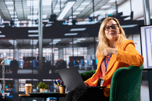 Fototapeta Female business leader in a professional office strategizing for development success, discussing with shareholders