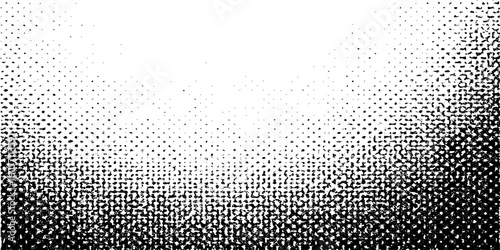 Grunge halftone gradient background faded dotted grit noise texture. Black and white rasterized sand wallpaper.