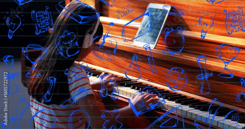 Chinese girl playing piano at home, wearing headphones, striped shirt with tablet and blue doodles